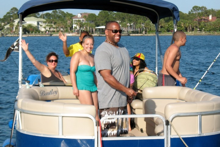 a group of people in a small boat in a body of water